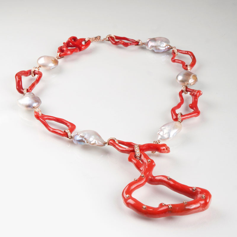 A modern coral pearl necklace with diamonds