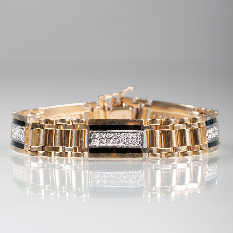 A golden bracelet with diamonds and onyx