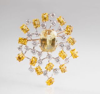 A high carat goldberyll diamond brooch with a natural yellow sapphire