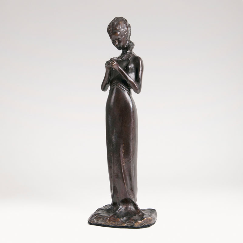 A bronze sculpture 'Hair braiding girl'