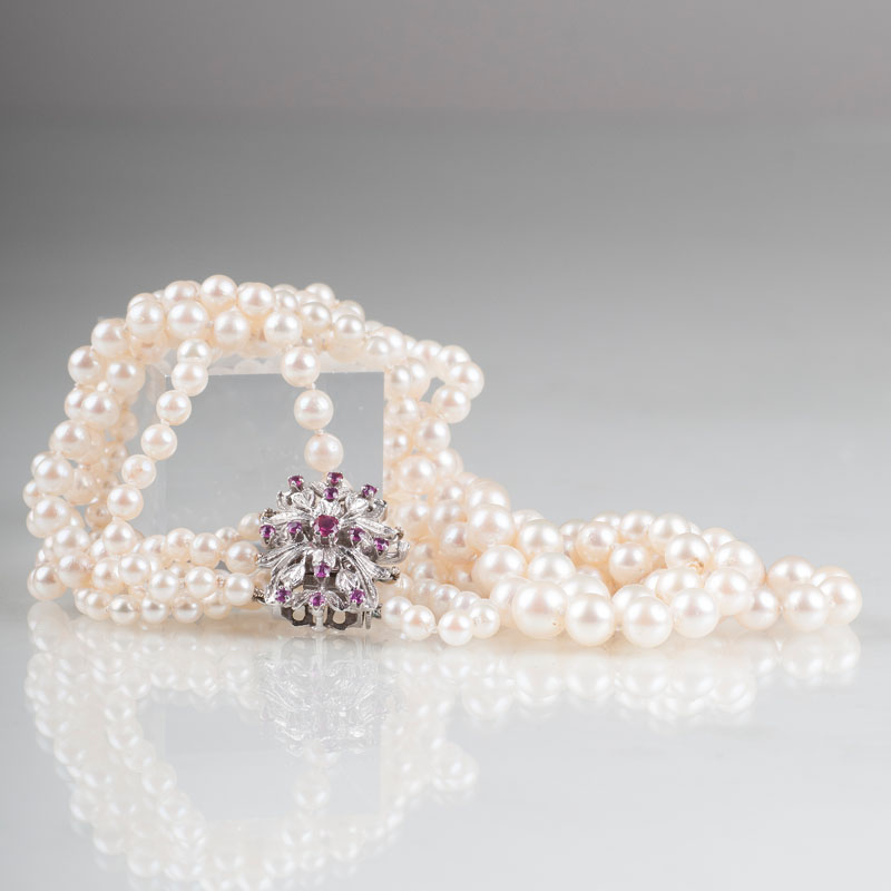 A pearl necklace with ruby diamond clasp