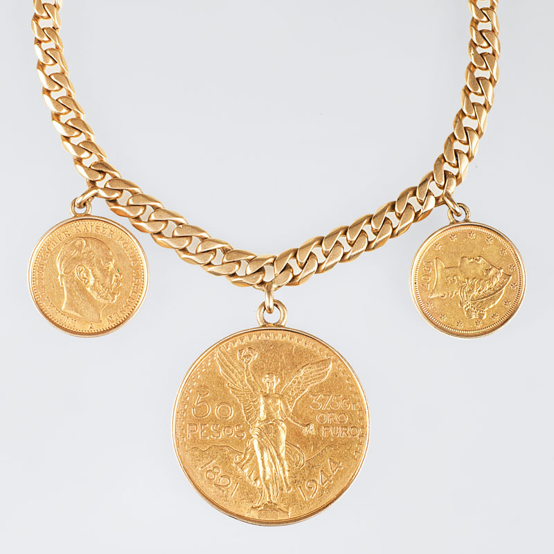 A curb chain bracelet with 3 coin pendants in gold