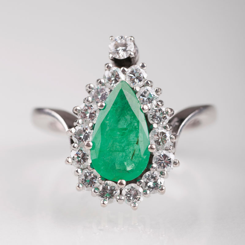 An emerald diamond ring