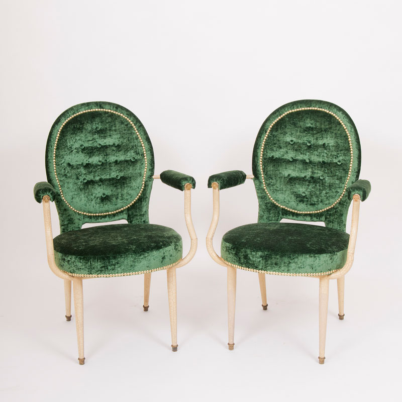 A pair of medaillion shaped armchairs in the style of André Arbus