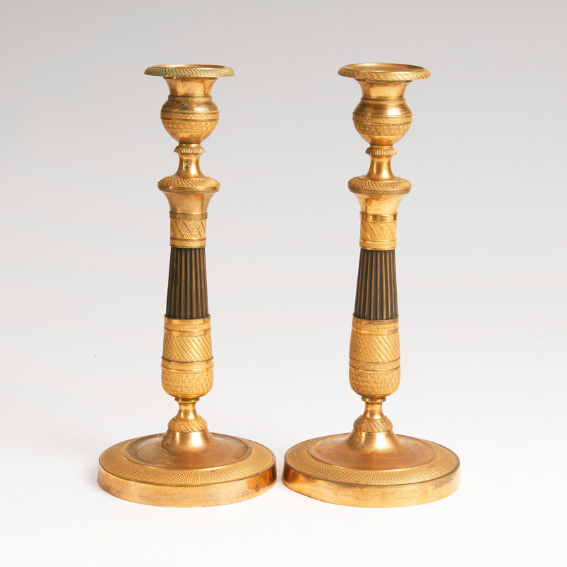 A pair of firegilt Empire candlesticks