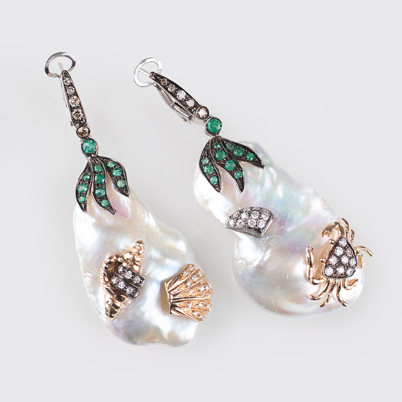 A modern pair of pearl earpendants with emeralds and diamonds