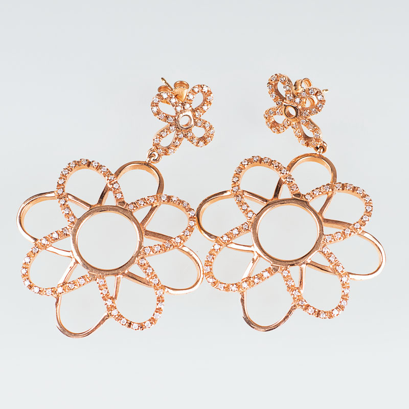 A pair of modern gold diamond earrings in flowershape
