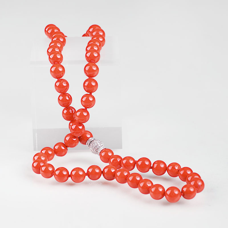 A coral necklace with diamond clasp