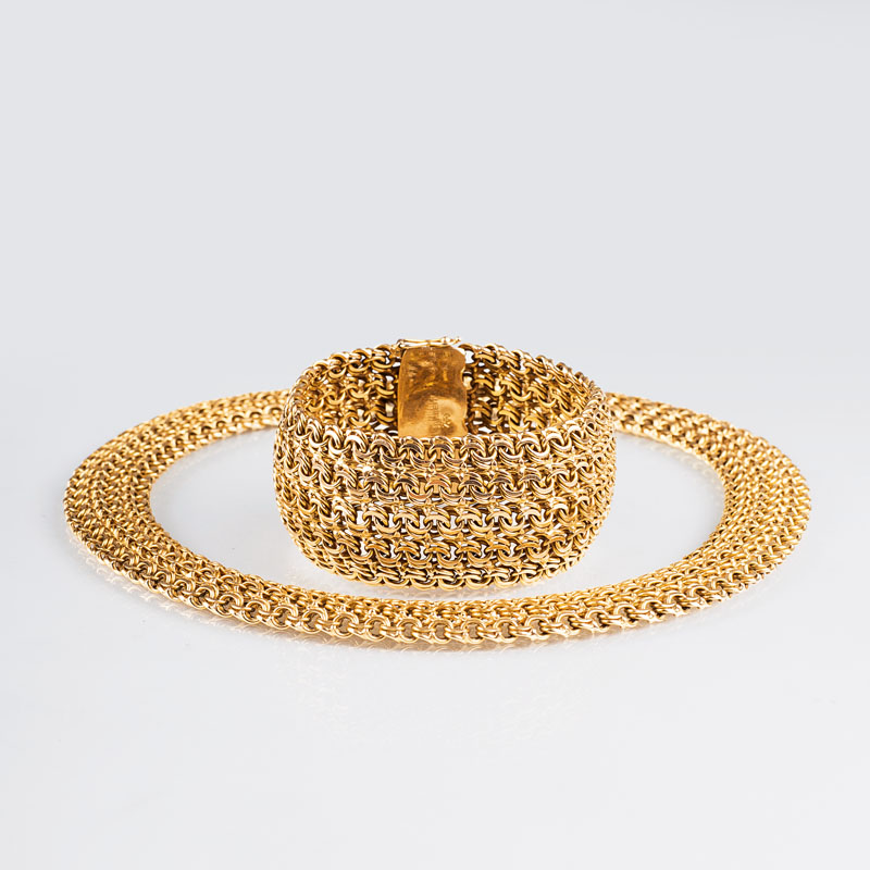 A golden necklace with matching bracelet