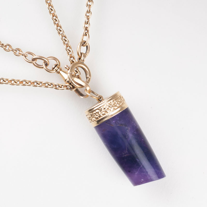 A long golden necklace with amethyst pendant