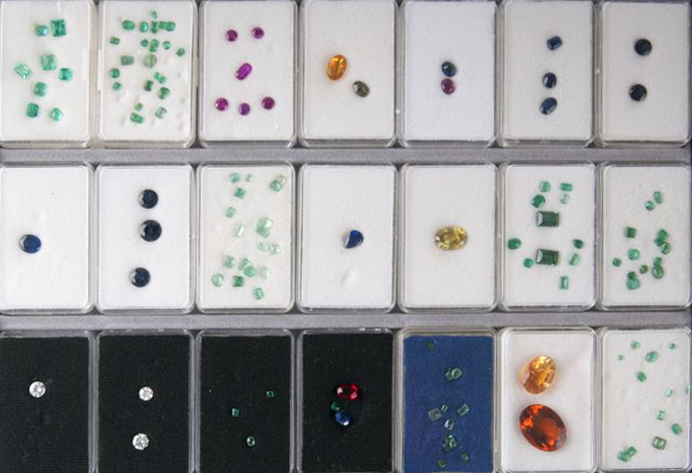 21 boxes with loose stones in faceted and cabochon cut