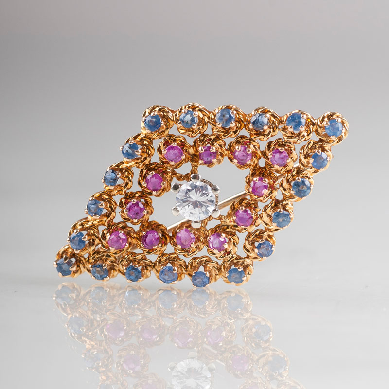 A small sapphire ruby brooch with one solitaire