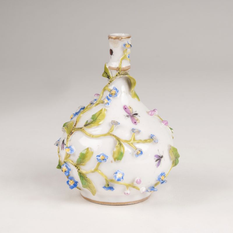 A miniature vase with sculptural flowers