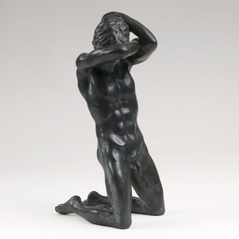 A bronze sculpture 'Kneeling male nude'
