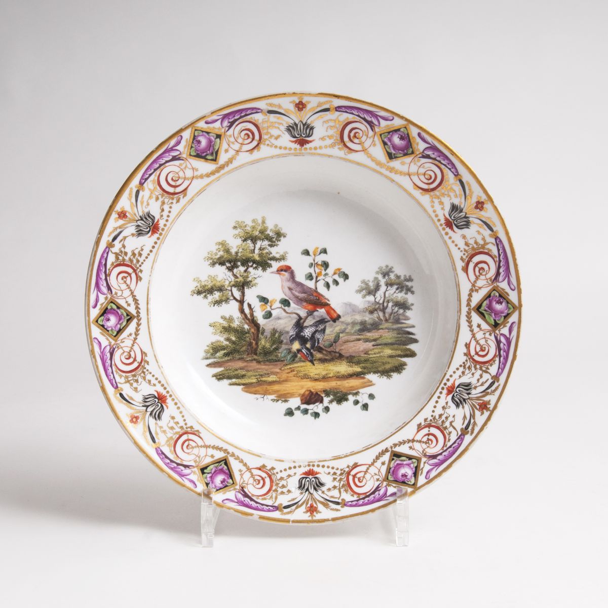 A plate with bird painting and ornamental border