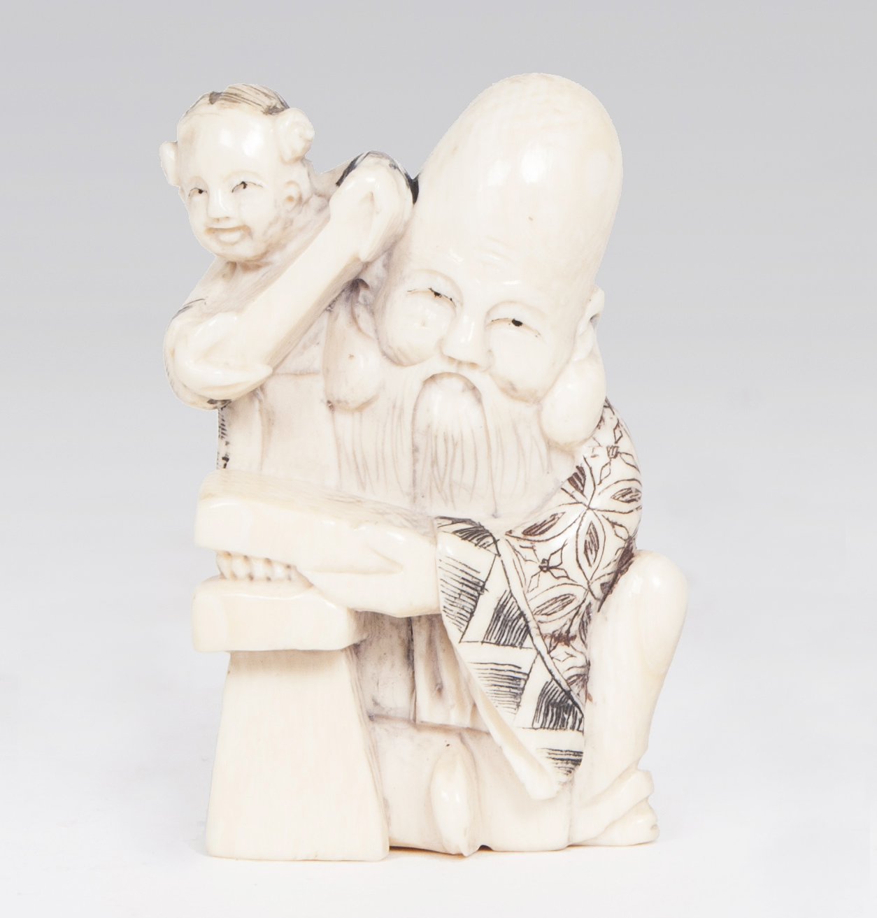 A netsuke 'Jurôjin, god of longevity, with a boy'