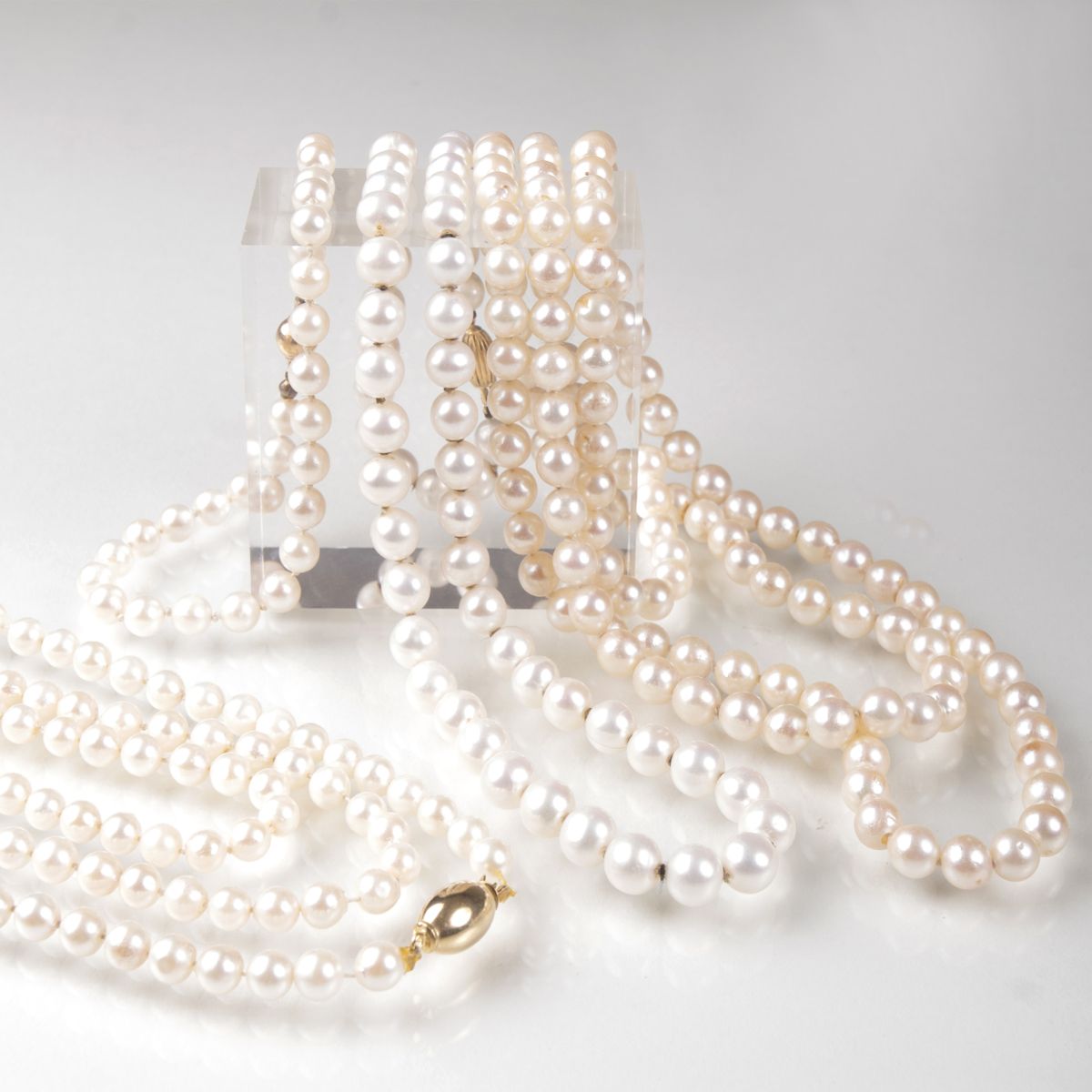 Three pearl necklaces and one pearl bracelet