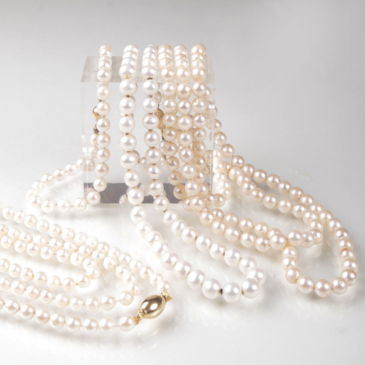 Three pearl necklaces and one pearl bracelet