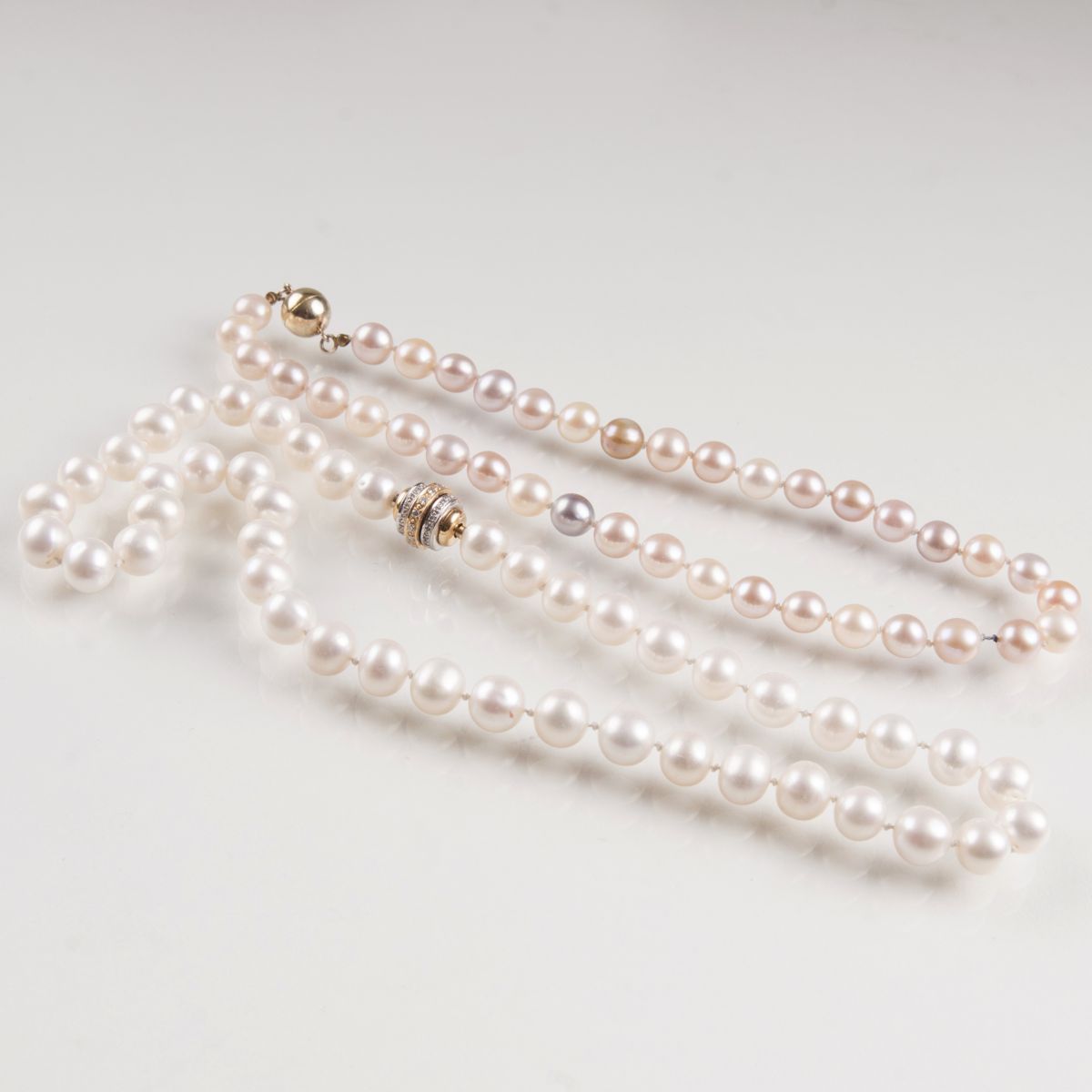 Two pearl necklaces and one diamond clasp