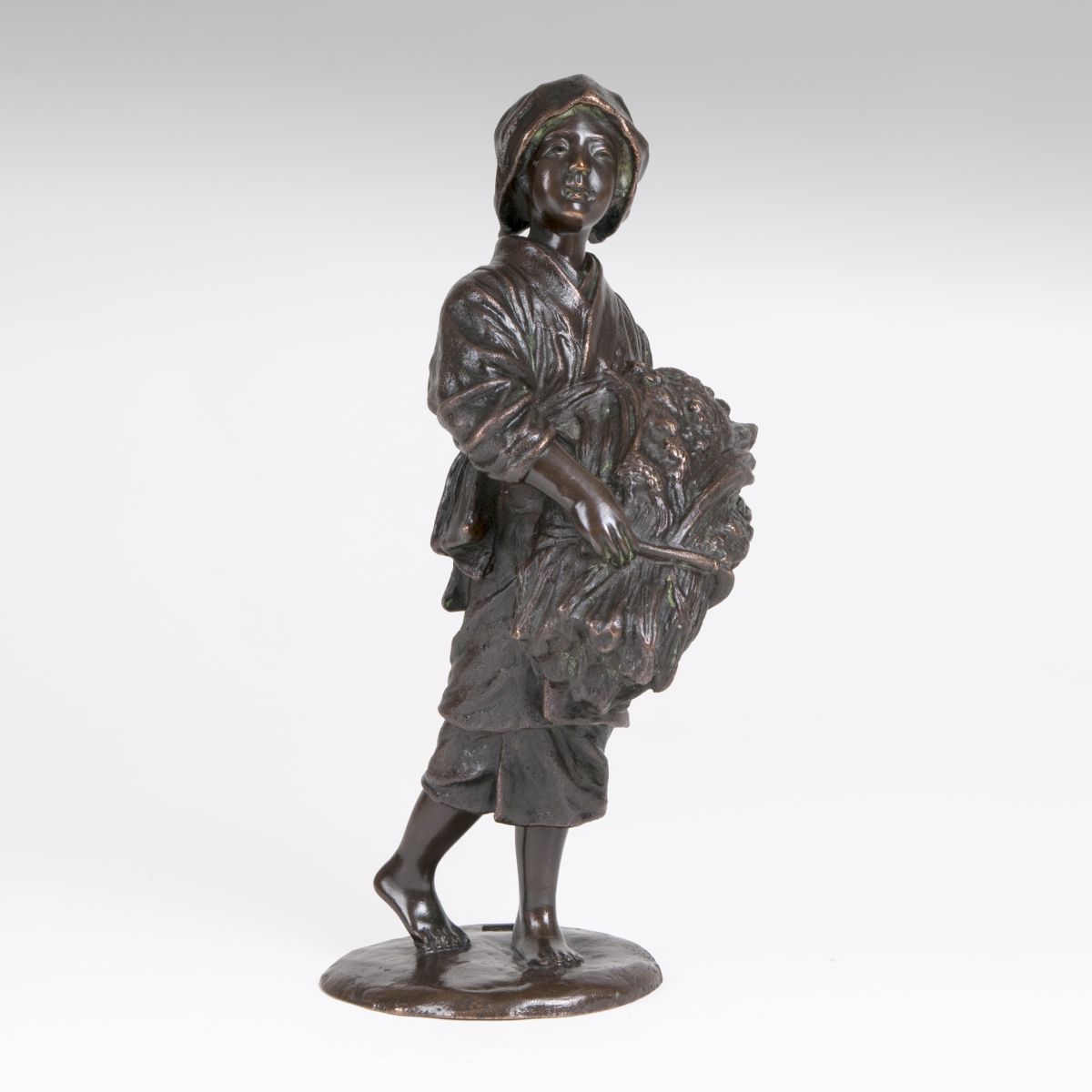 A Japanese bronze sculpture 'Peasant woman with sheaf of grain'