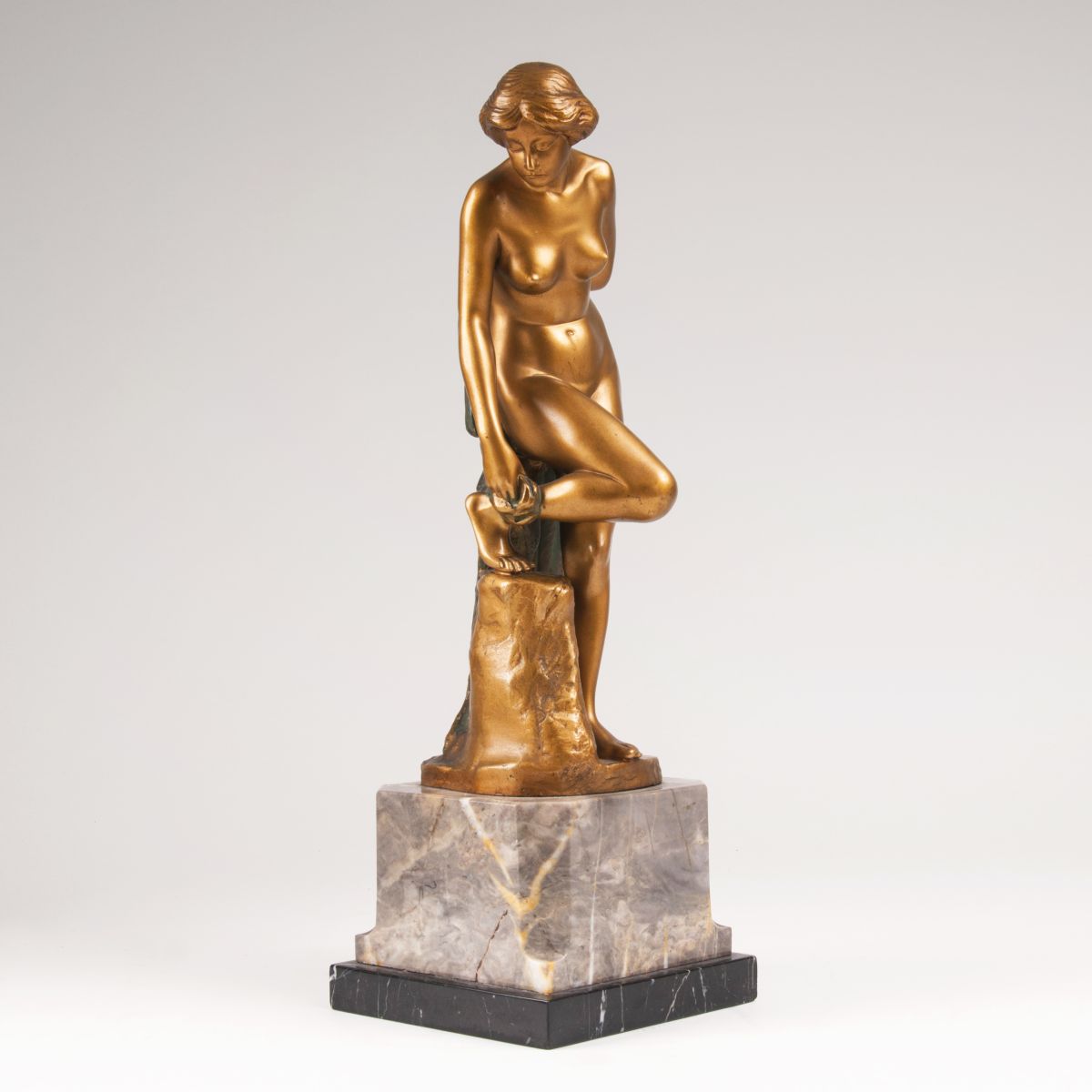 A bronze figure 'Female Nude after the bath'