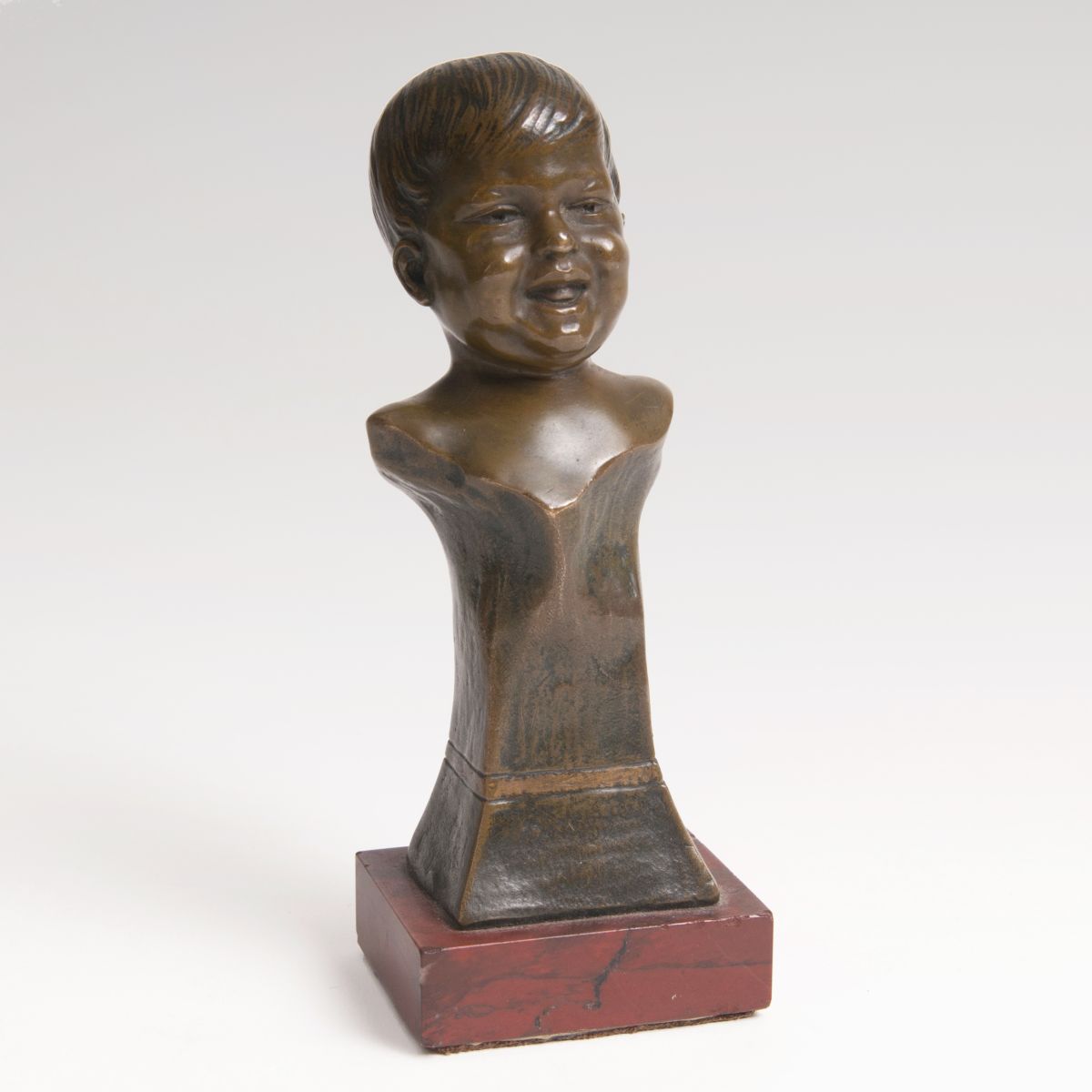 A small bronze bust 'Laughing Boy'
