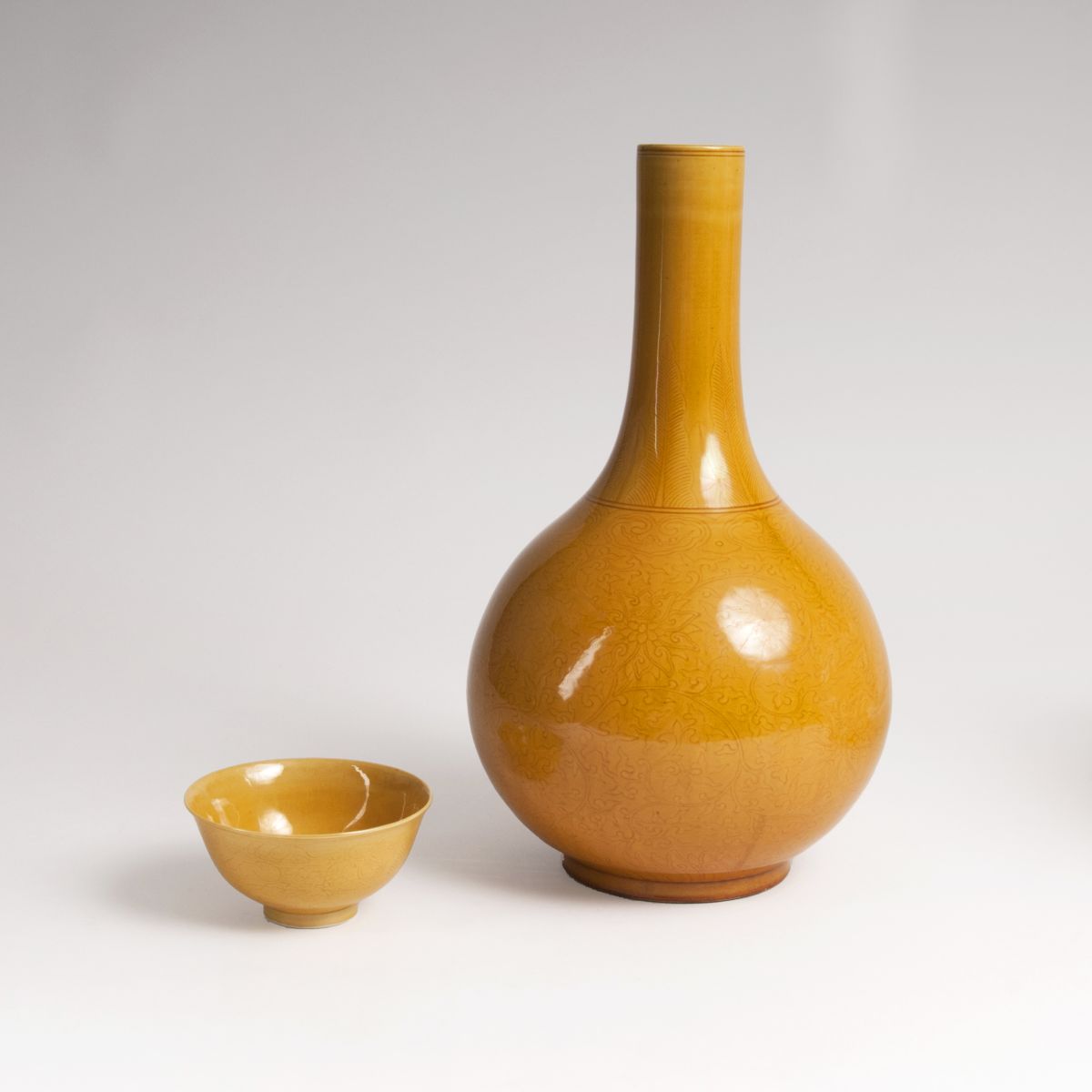 A baluster-shaped vase and bowl with yellow glaze