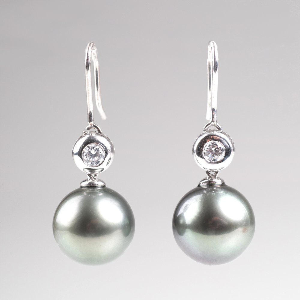A pair of Tahiti pearl earrings with small solitaire diamonds