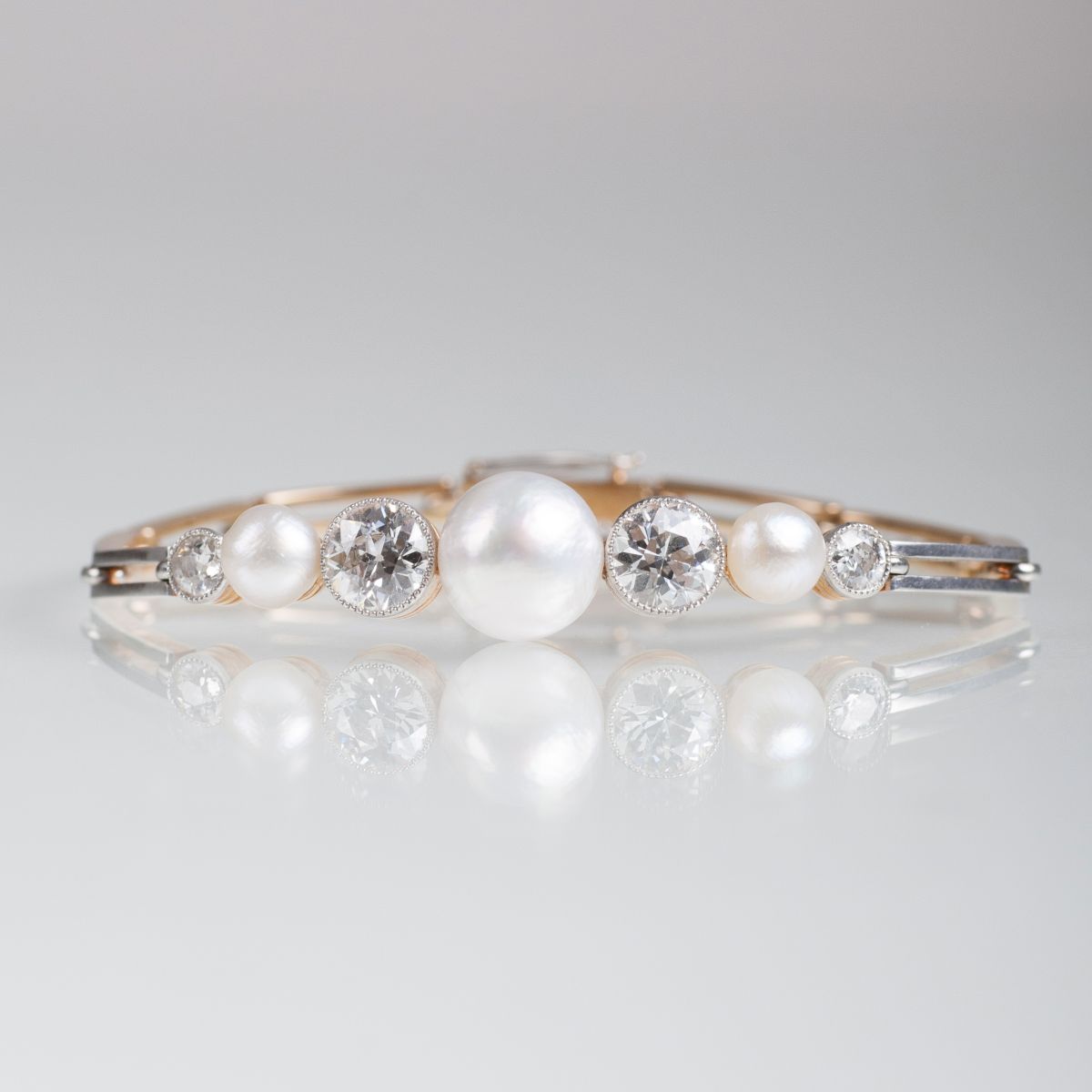 A fine Art Nouveau bangle bracelet with pearls and old cut diamonds