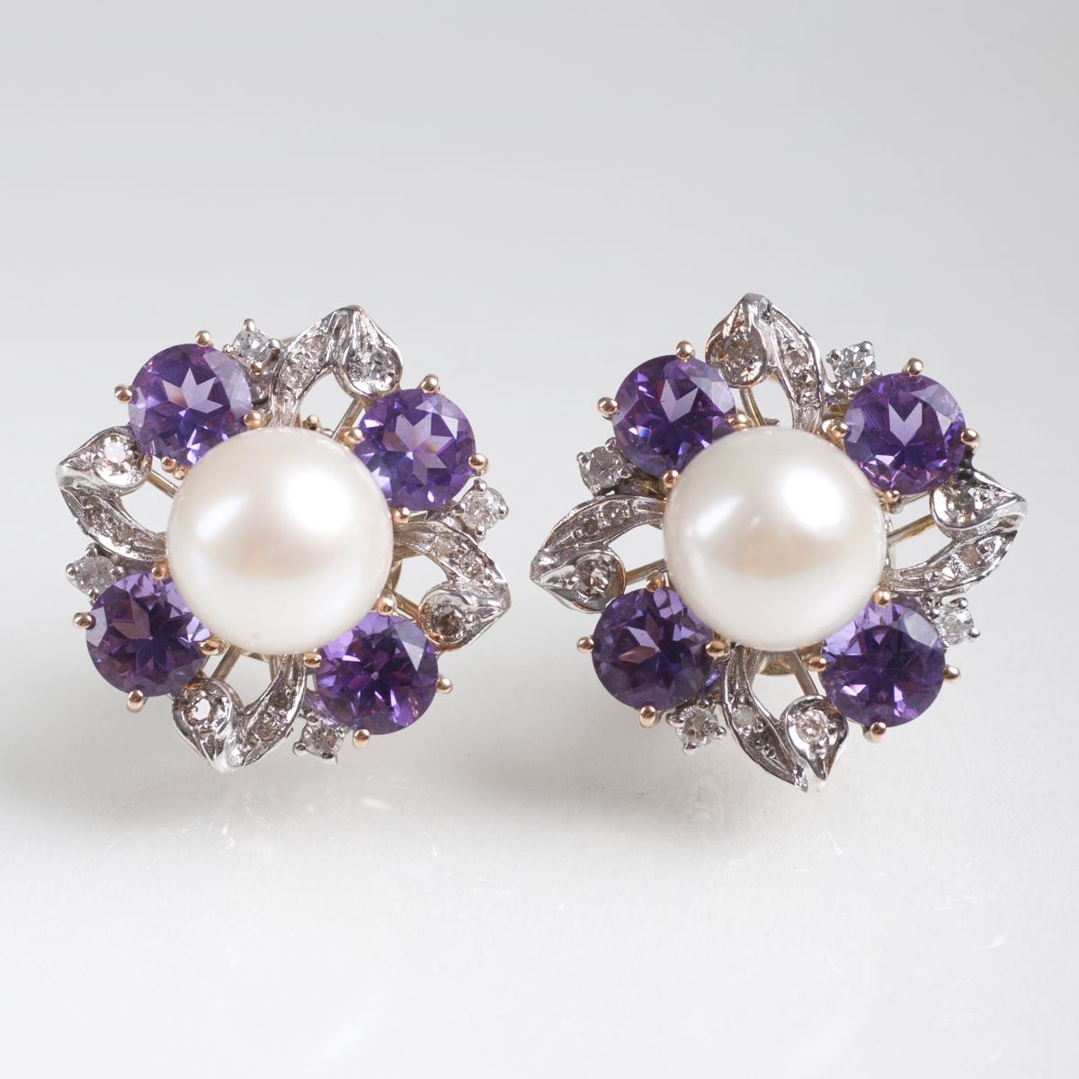 A pair of pearl amethyst diamond earrings