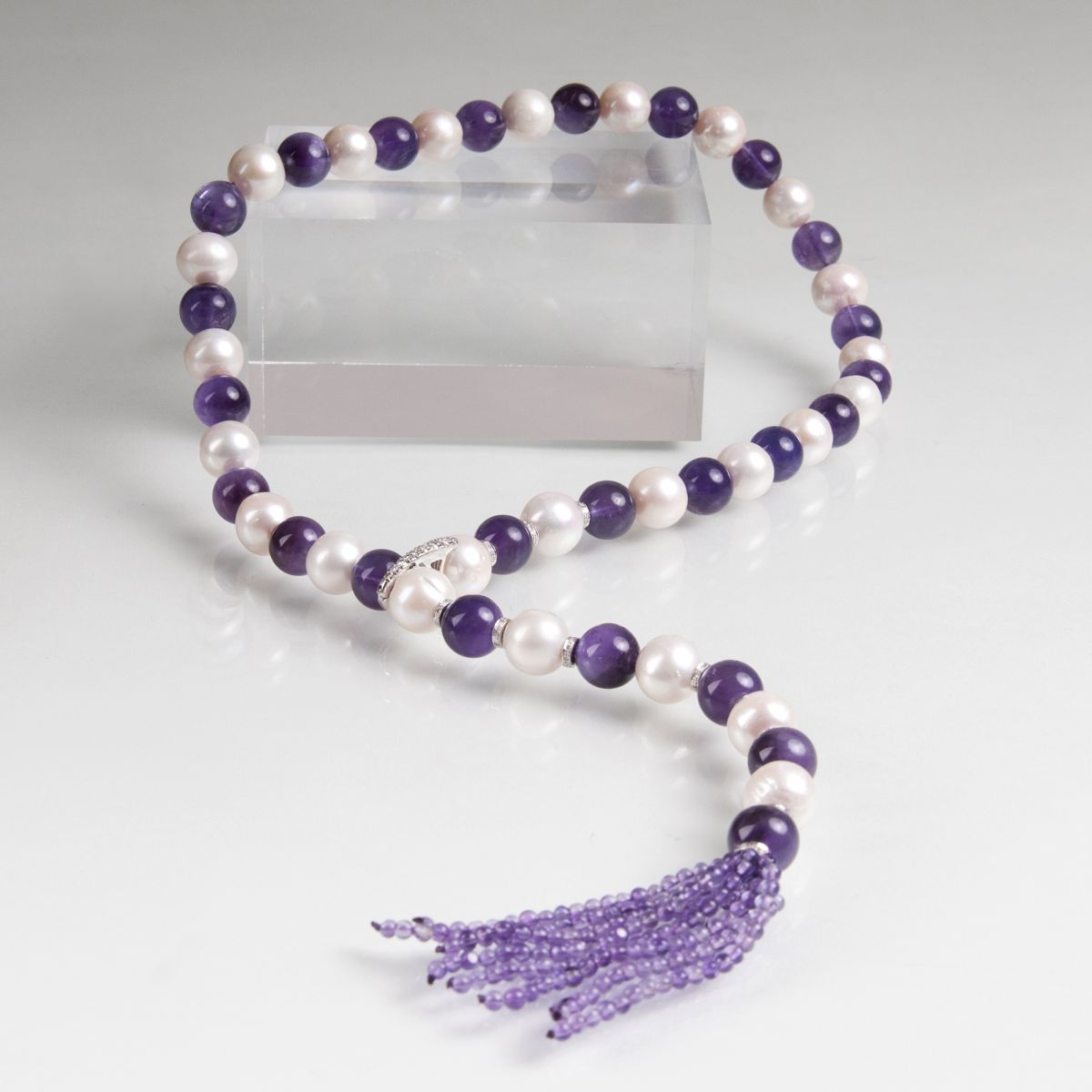 A long pearl amethyst necklace with tassel pendant