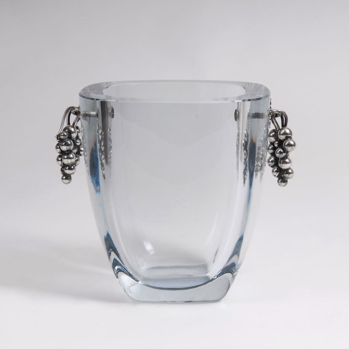 An elegant ice bucket with silver grapes