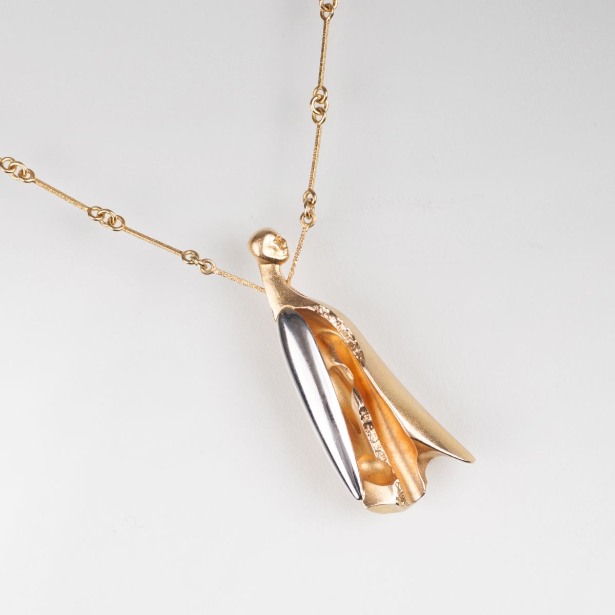 A modern gold necklace with figural pendant by Björn Weckström