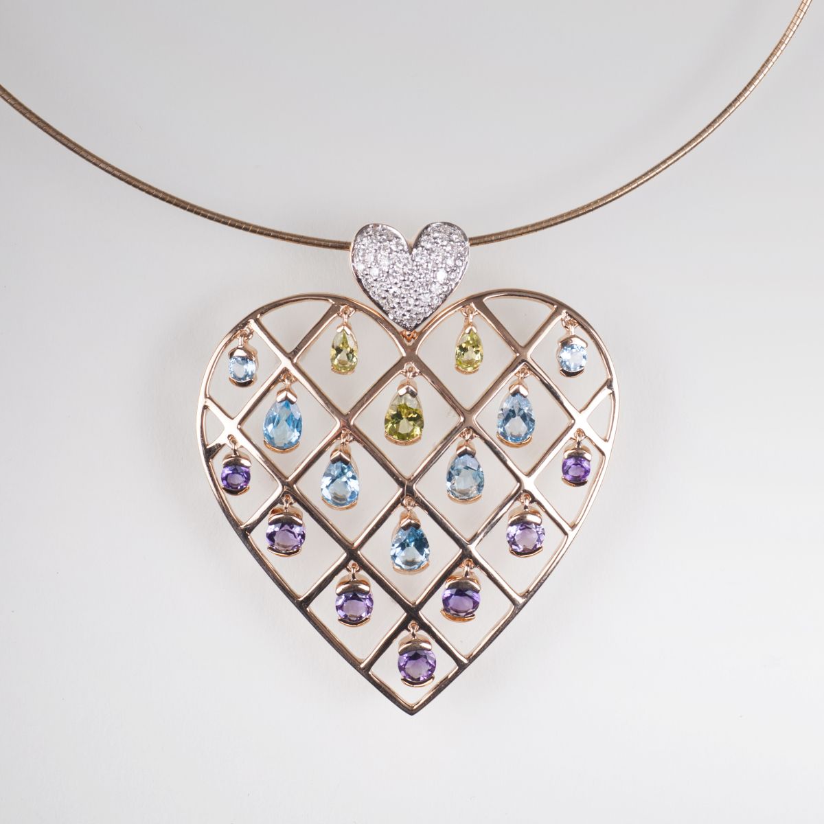 A heart pendant with colourful gemstone setting and necklace