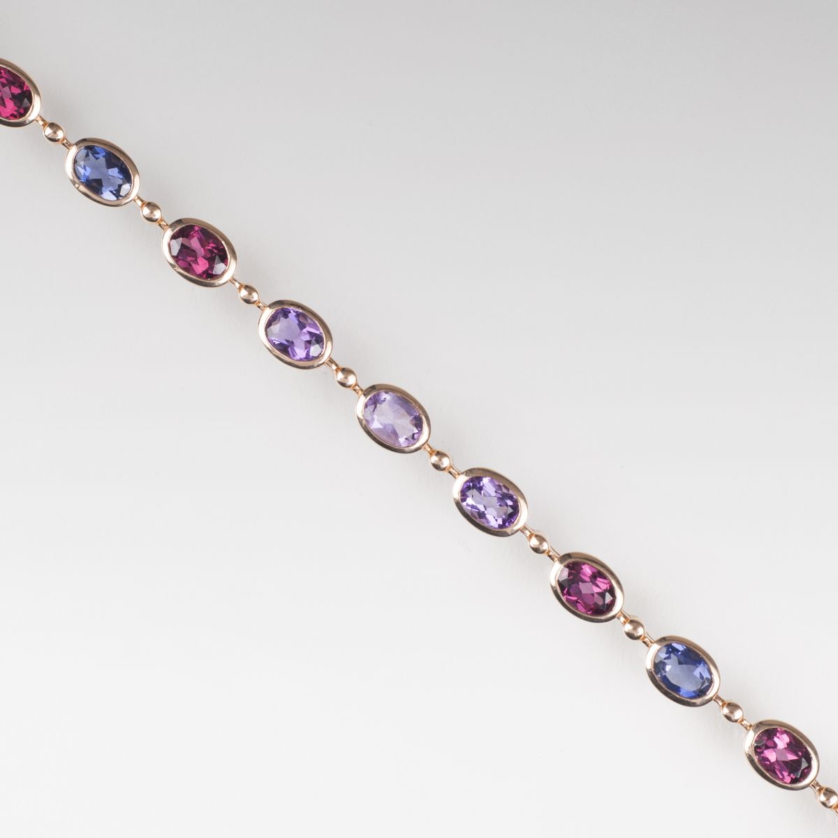 A bracelet with amethyst, rhodolith and iolith
