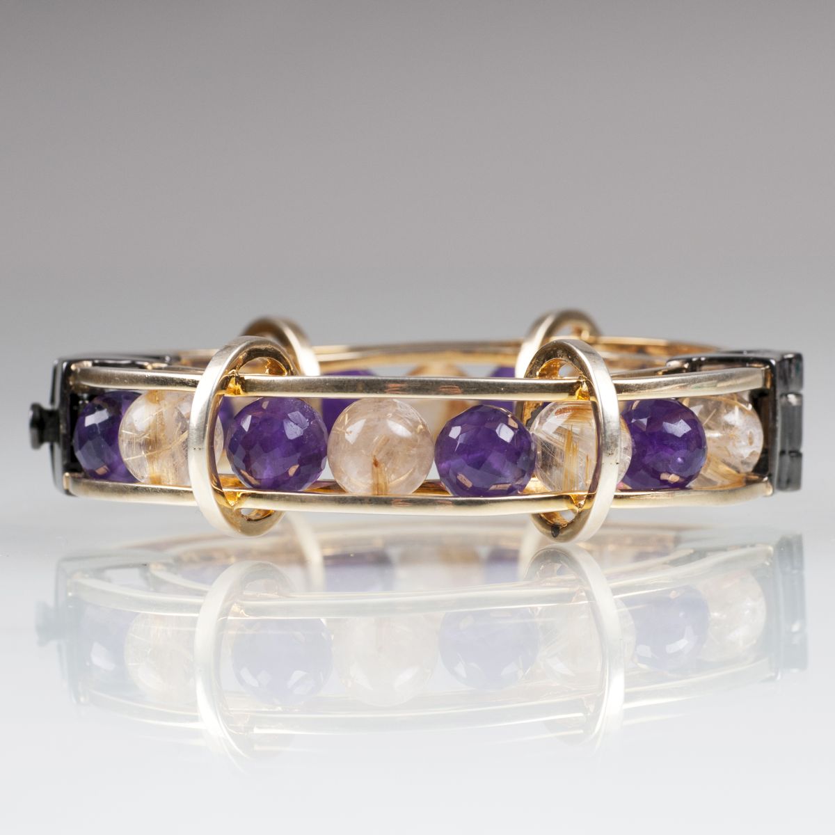 An extraordinary bangle bracelet with amethyst and rutil quartz