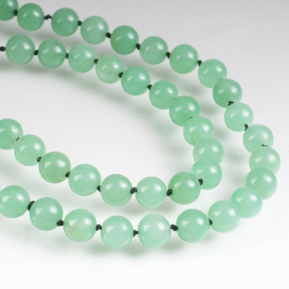 A long jade green quartz necklace