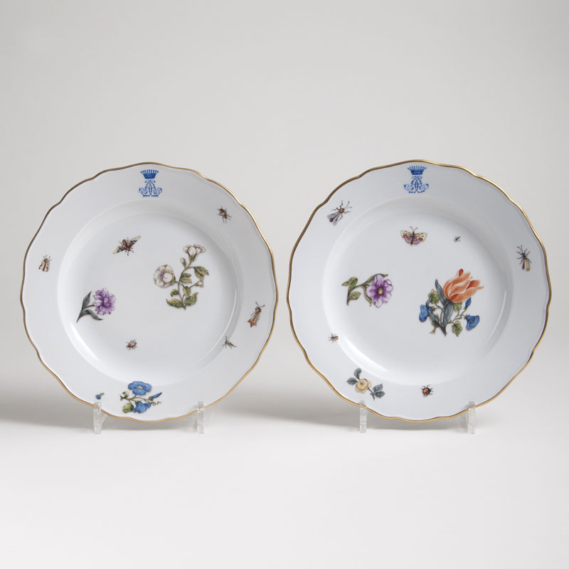 A pair of monogram plates with flowers and insects