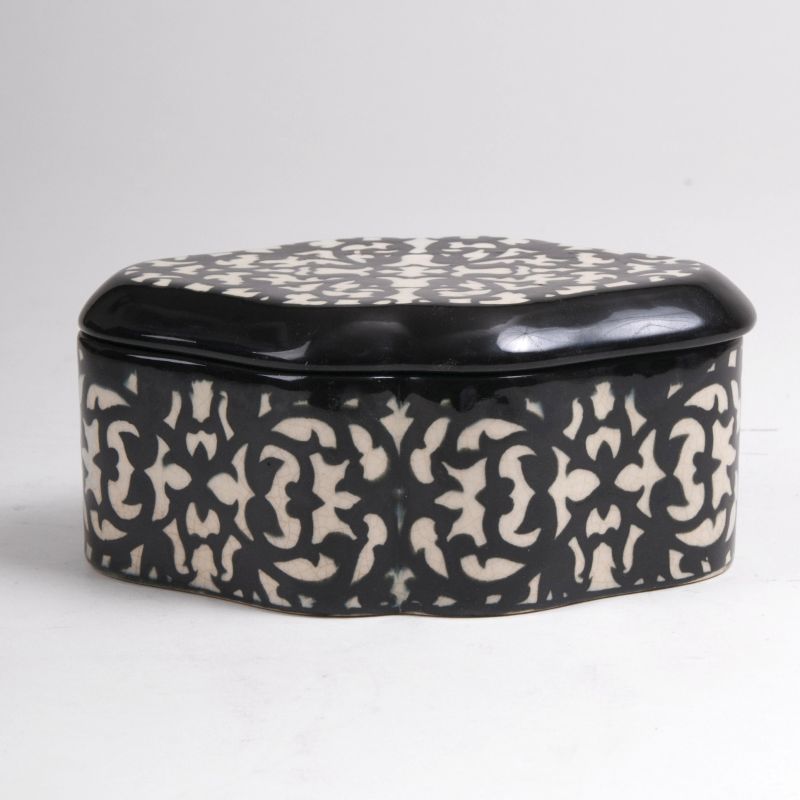 An Art Nouveau box with black and white floral decoration