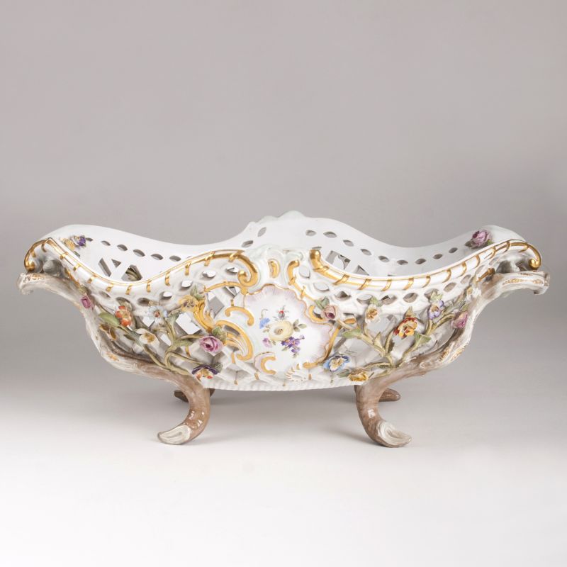 A Large Oval Basket with Latticework and Sculptural Flowers