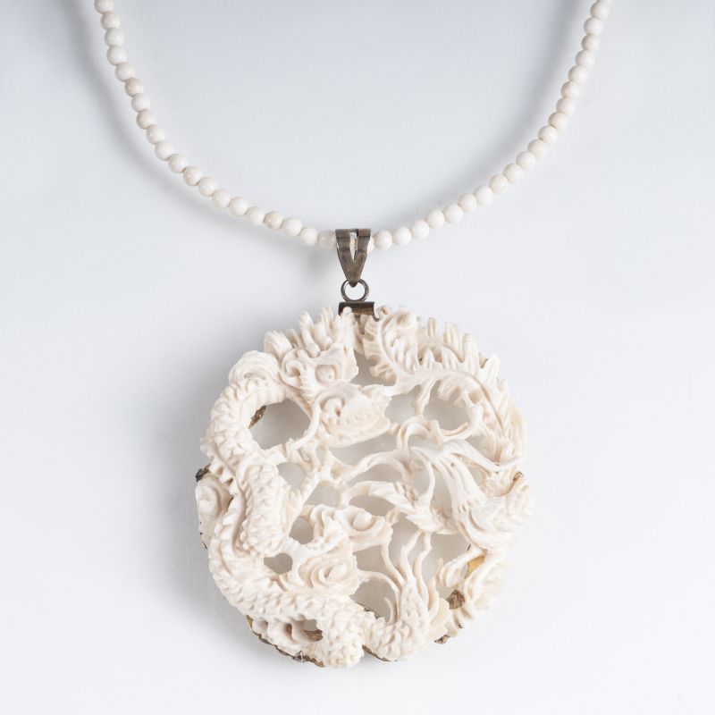 An antique ivory pendant 'Dragon and Phoenix'