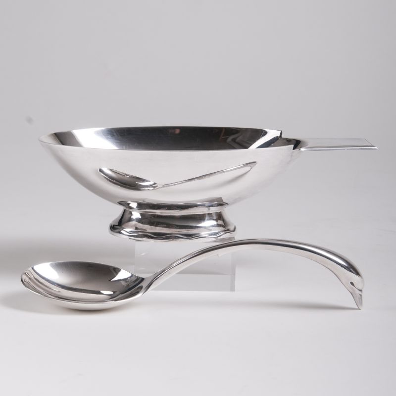 An elegant saucier with a swan head spoon