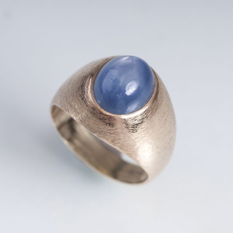 A golden ring with sapphire cabochon