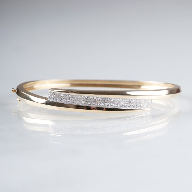 A golden bangle bracelet with diamonds