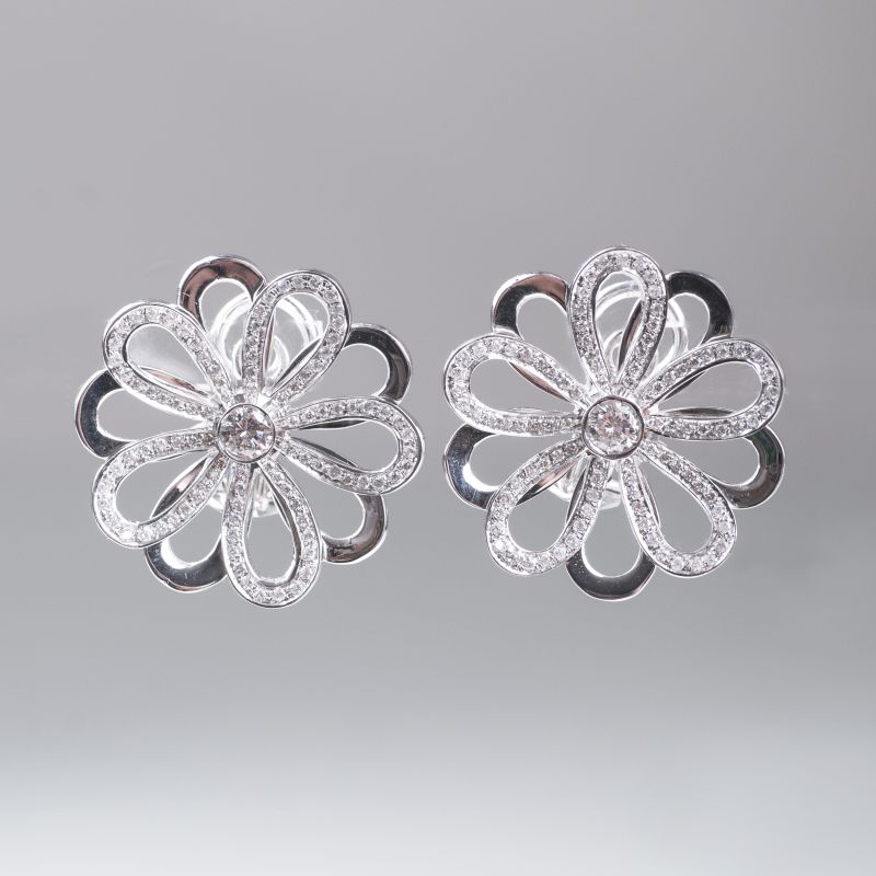 A pair of flowershaped diamond earrings