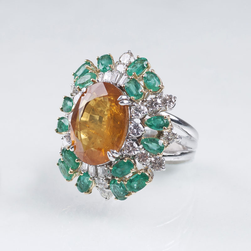 A highcarat cocktailring with yellow sapphire, emeralds