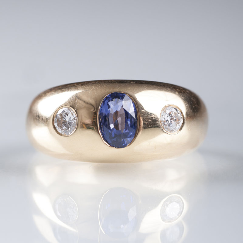 A gold ring with sapphire and diamonds