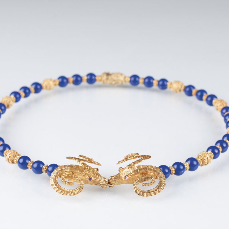 A lapis lazuli gold necklace with heads of rams