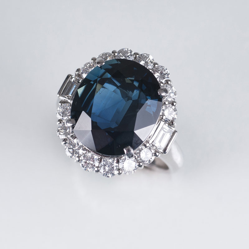 A very fine ring with one natural sapphire and diamond settings