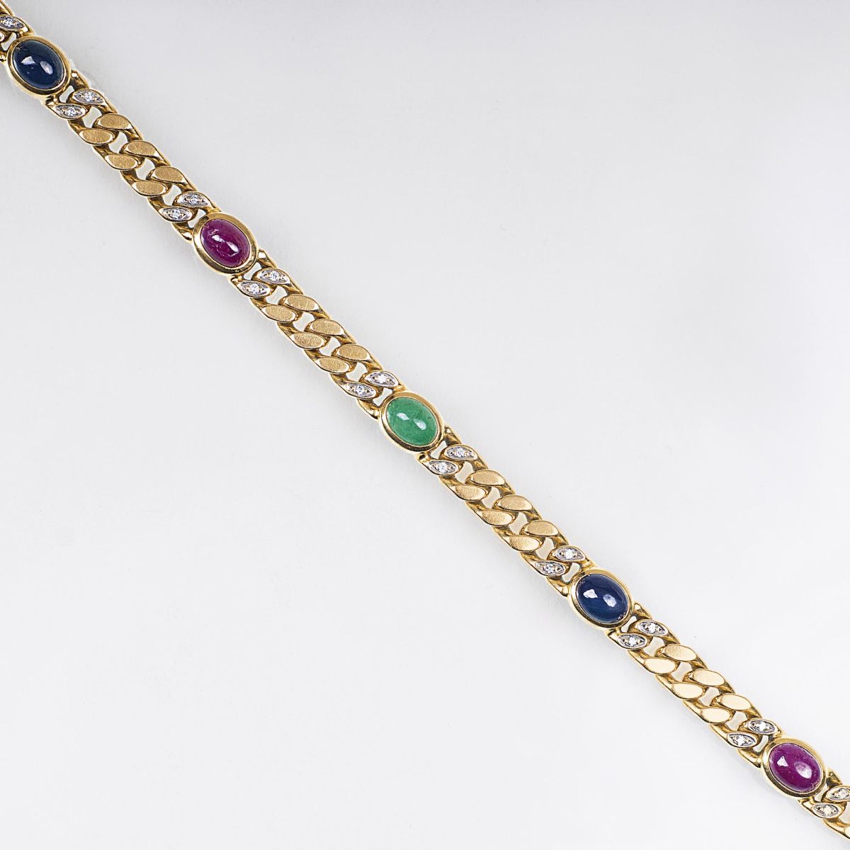 A Gold Curb Chain Bracelet with Gemstones